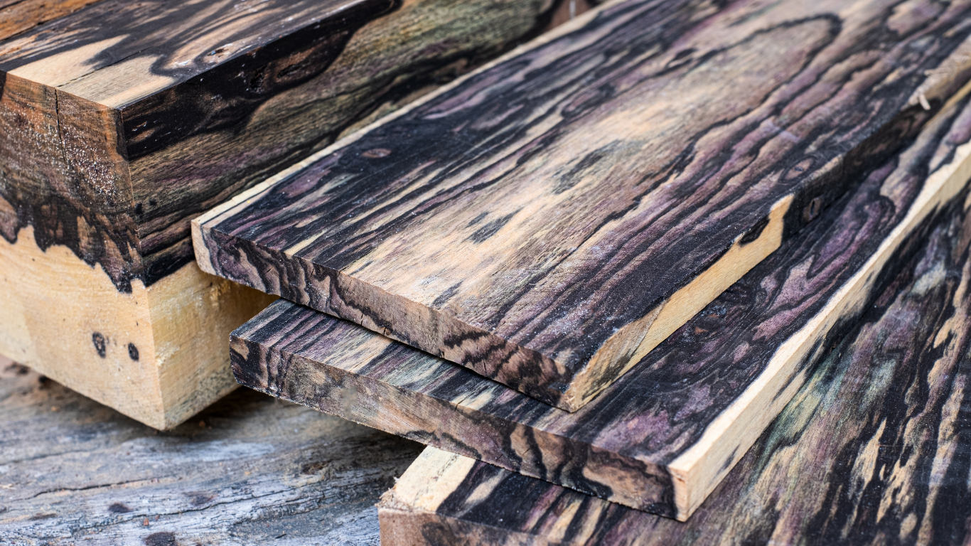 A stack of wooden boards sitting on top of each other on a table.