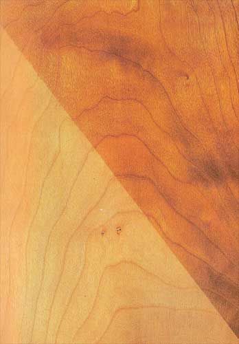 A close up of a piece of wood next to a piece of paper.