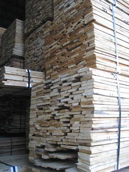 A large pile of wood stacked on top of each other