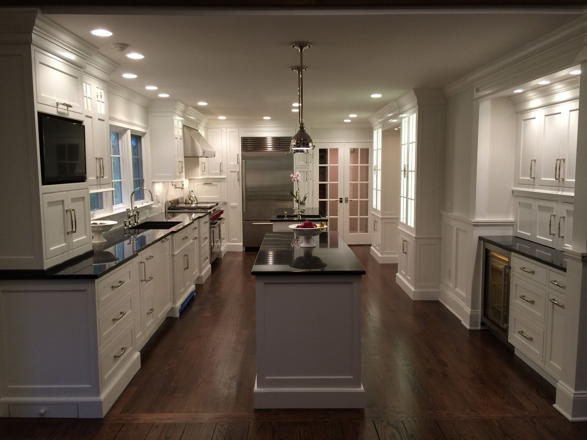 Luxury kitchen with white cabinets and stainless steel appliances