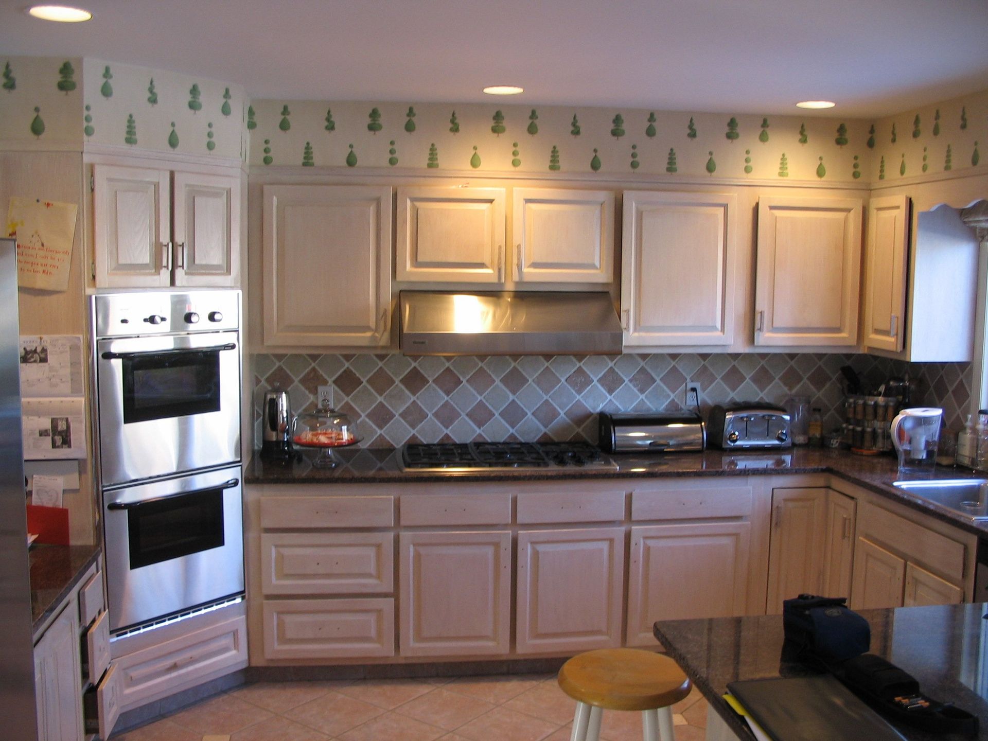 Kitchen with outdated wallpaper
