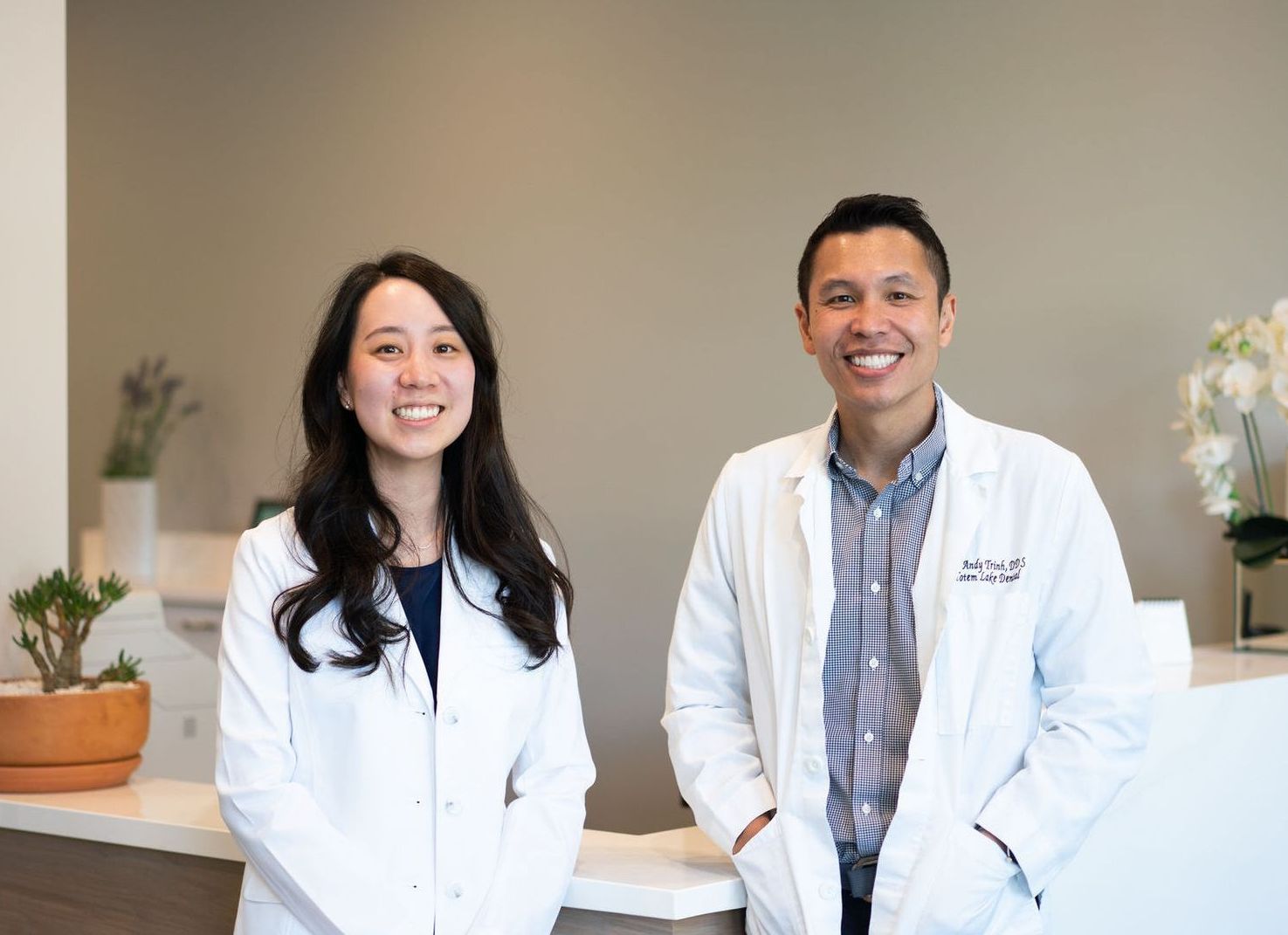 Dr. Trinh smiling in reception area of Totem Lake Dental in Kirkland, WA