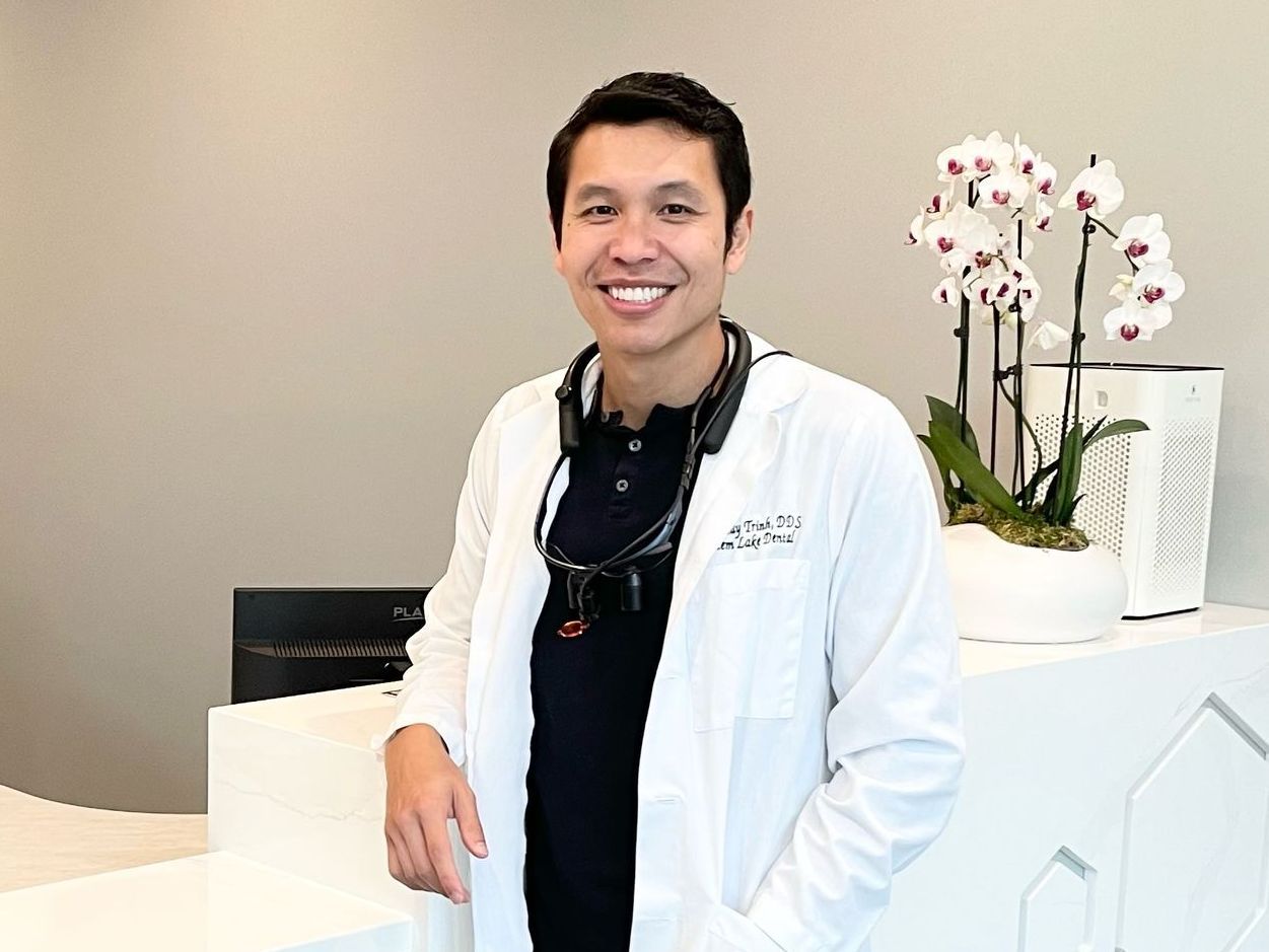 Dr. Trinh smiling in reception area of Totem Lake Dental in Kirkland, WA