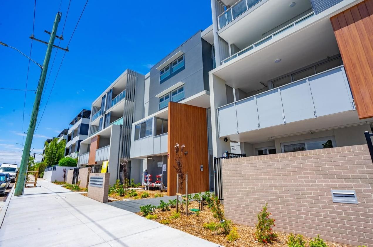 A Row of Apartment Buildings Sitting Next to Each Other on A Sunny Day — Duggan Mather Surveyors in Taylors Beach, NSW