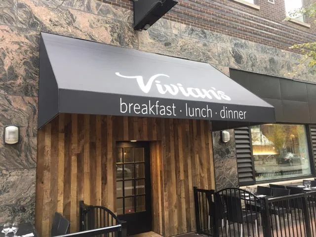 A restaurant with a black awning that says viviana breakfast lunch dinner.