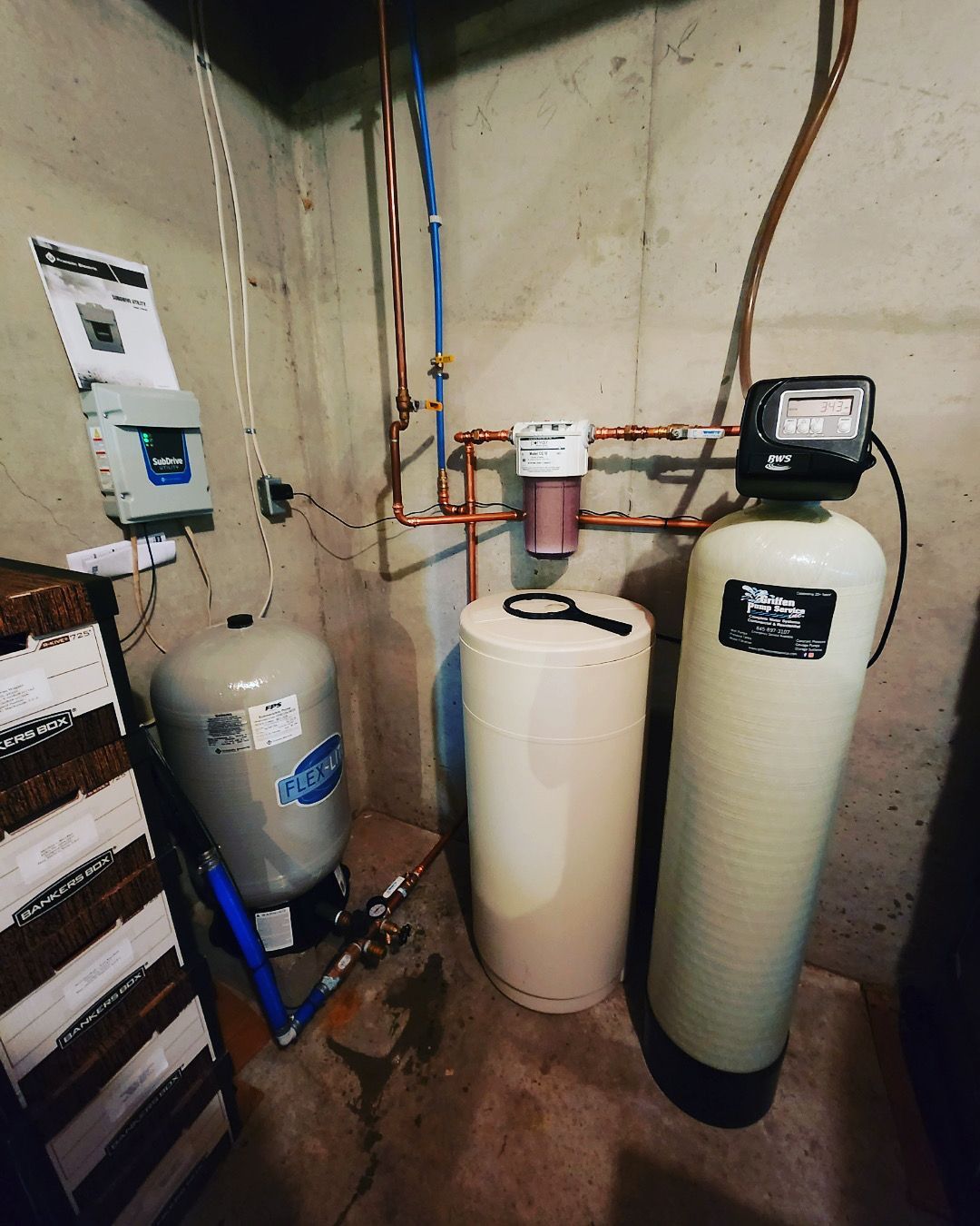 A room with two water tanks and a water filter