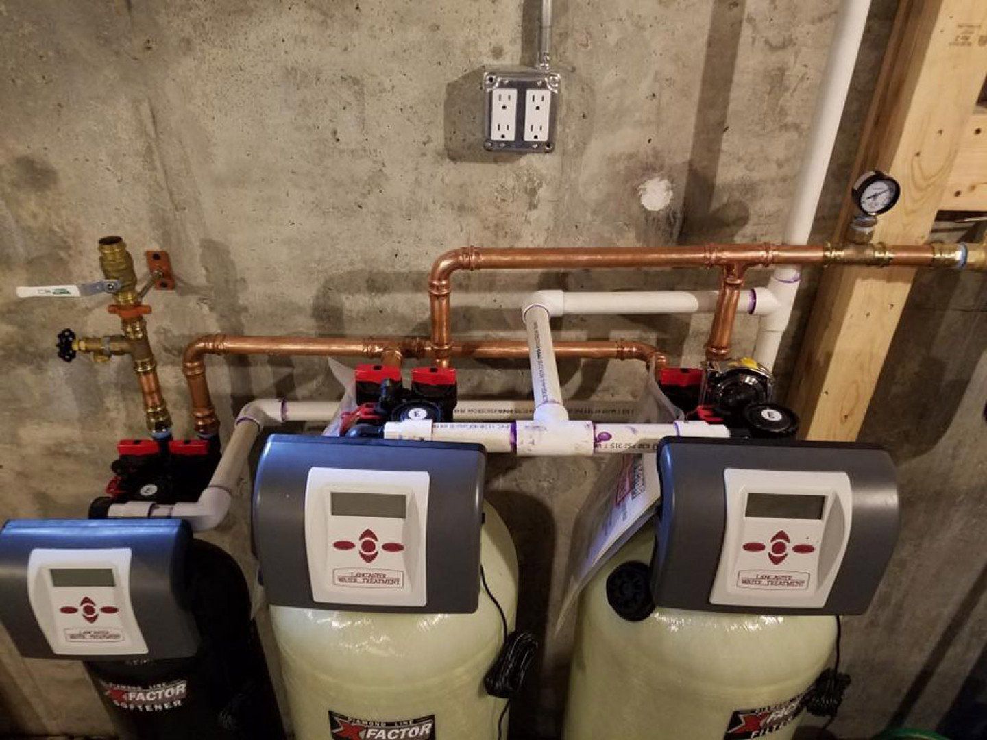 Two water treatment systems are connected to each other in a basement