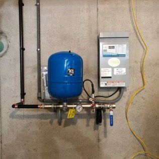 A blue tank is attached to a wall next to a yellow cord