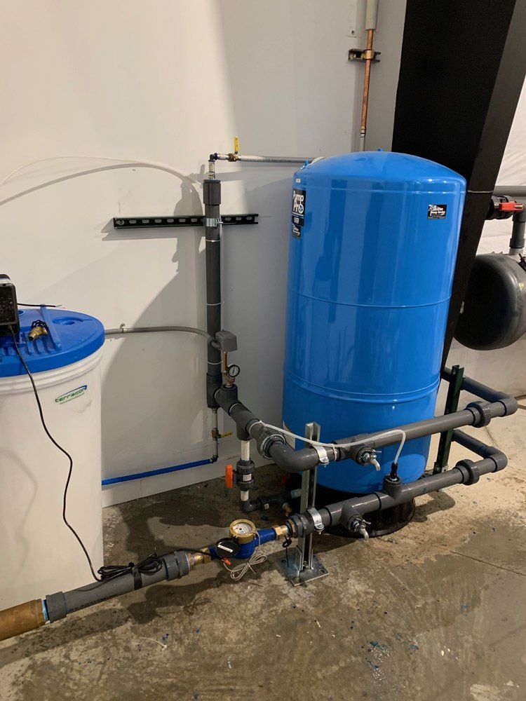 A blue tank is sitting next to a white tank in a room.