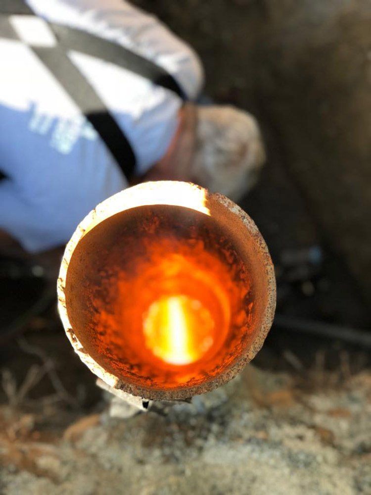 A close up of a pipe with a flame coming out of it