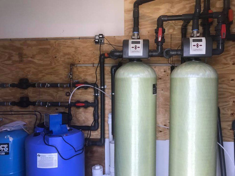 Two water tanks are sitting next to each other in a room.