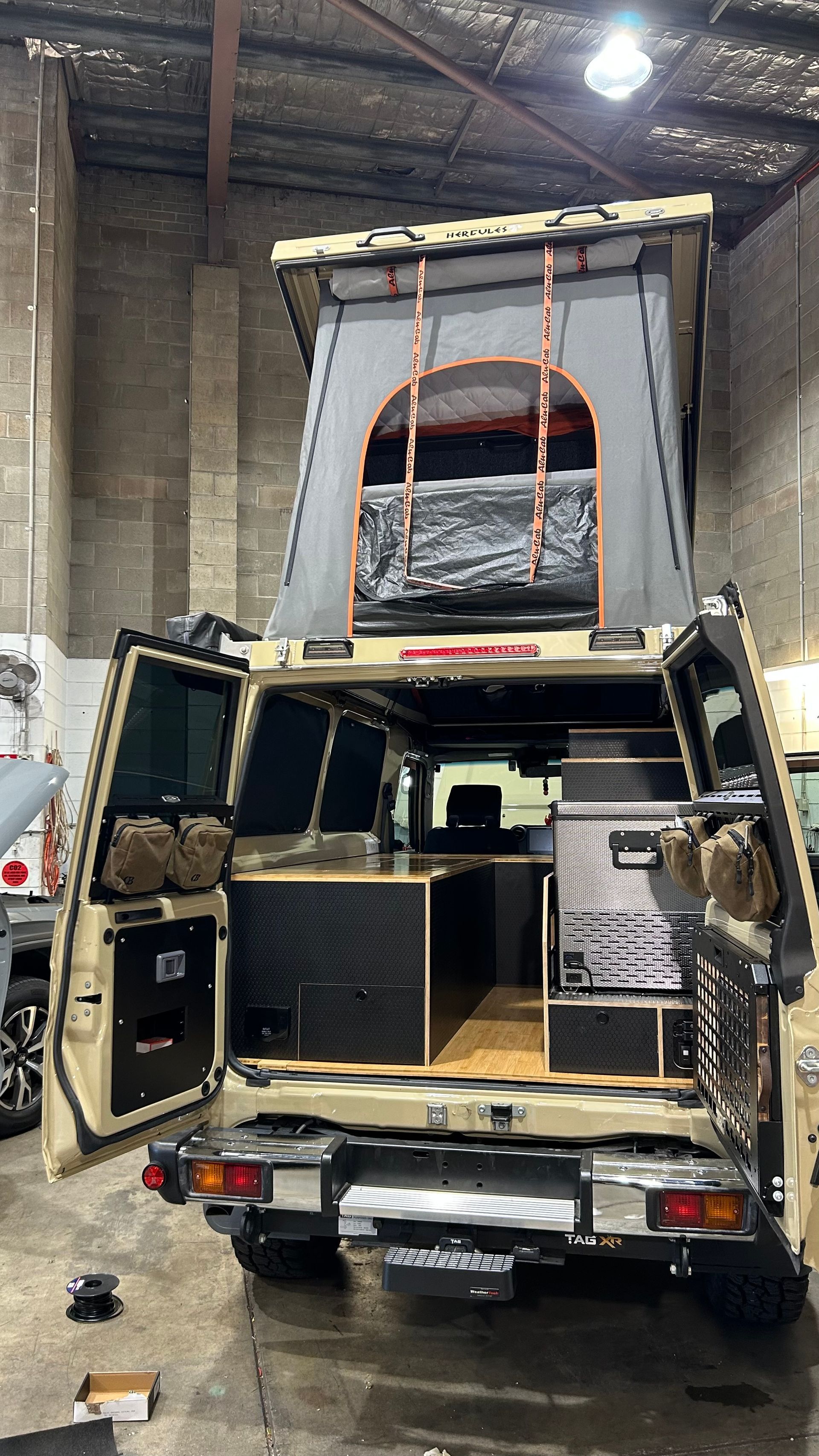 Van fit out with a pop up tent on top — Scotts Auto Air & Electrical In Wollongong, NSW