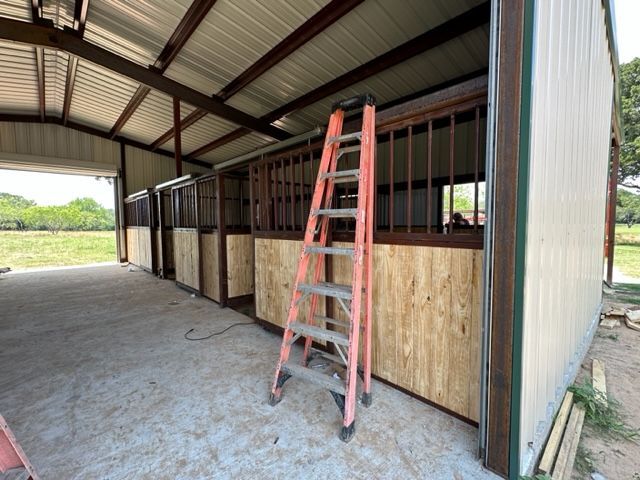 A ladder is leaning against the side of a barn.