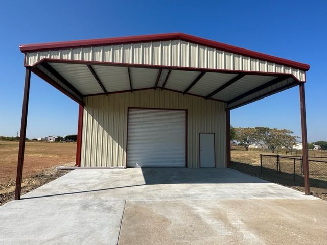 A garage with a red roof and a white door