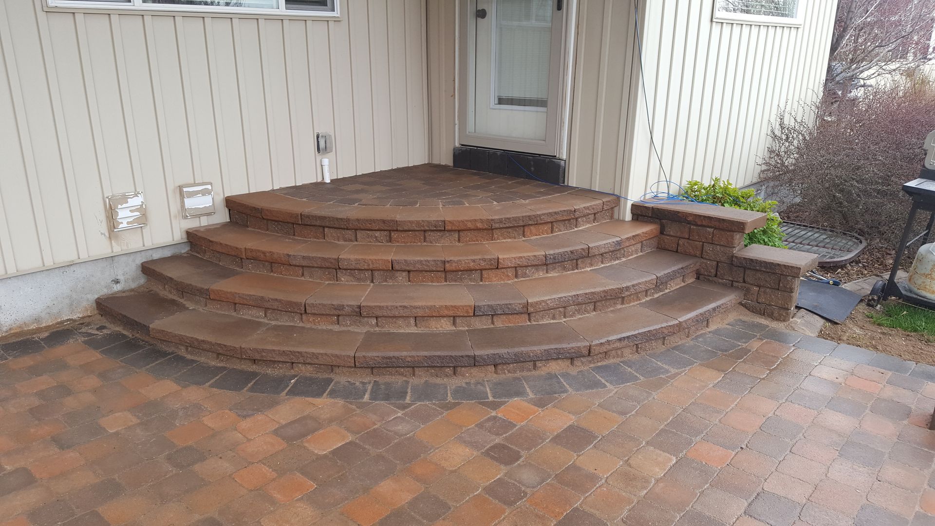 A set of brick steps leading up to a house.