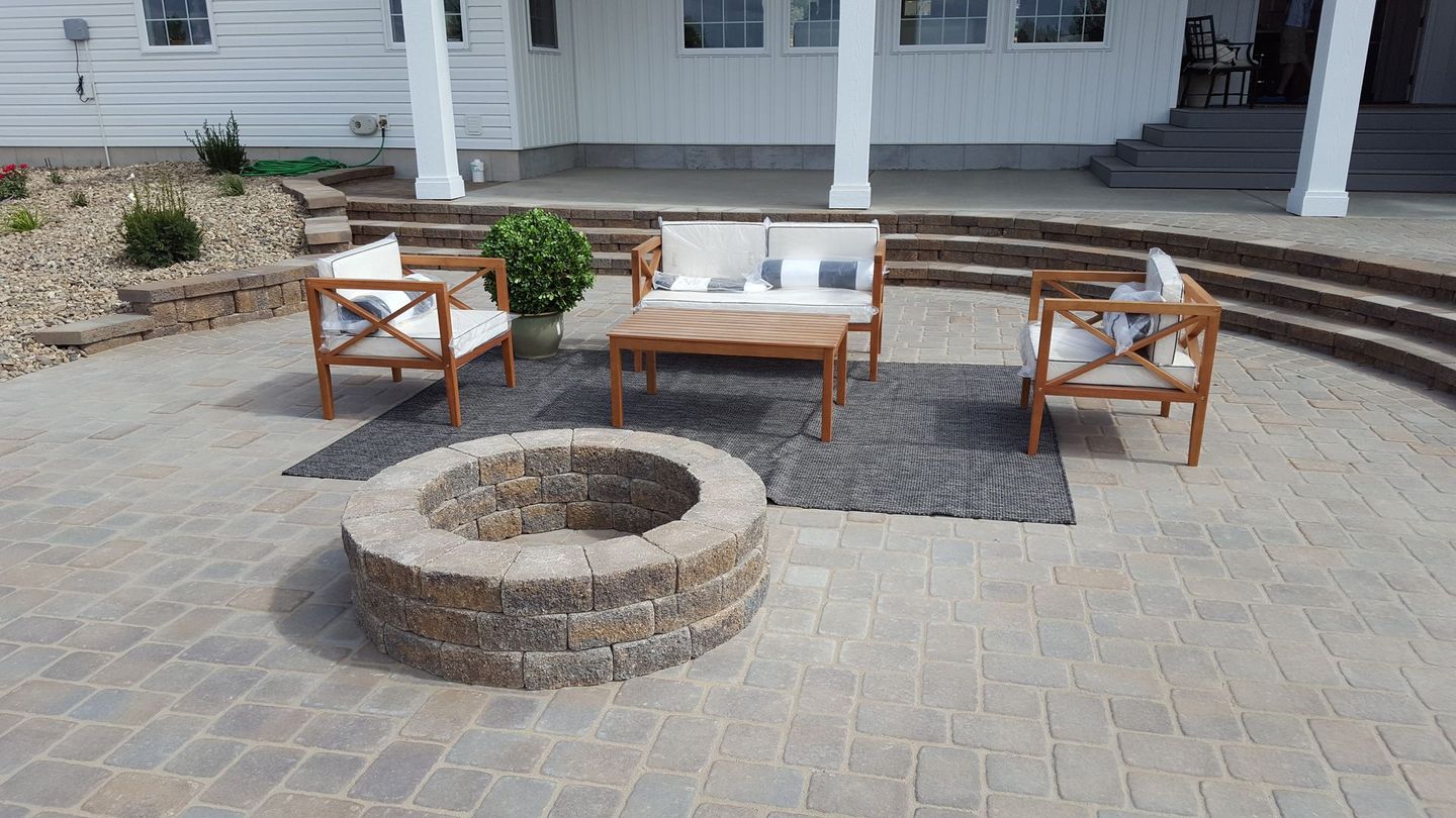 There is a fountain in the middle of the patio.