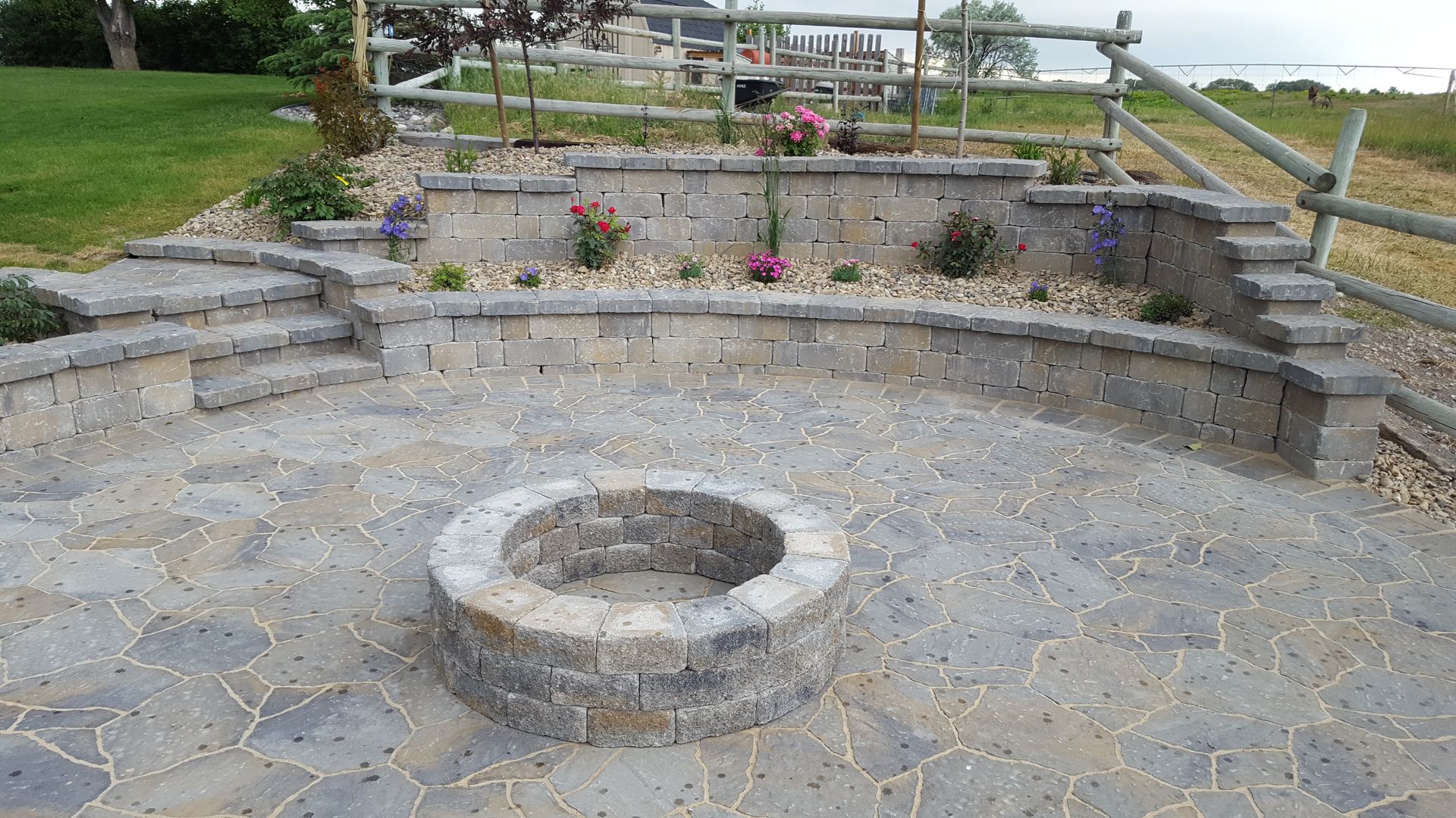 There is a fire pit in the middle of the patio.