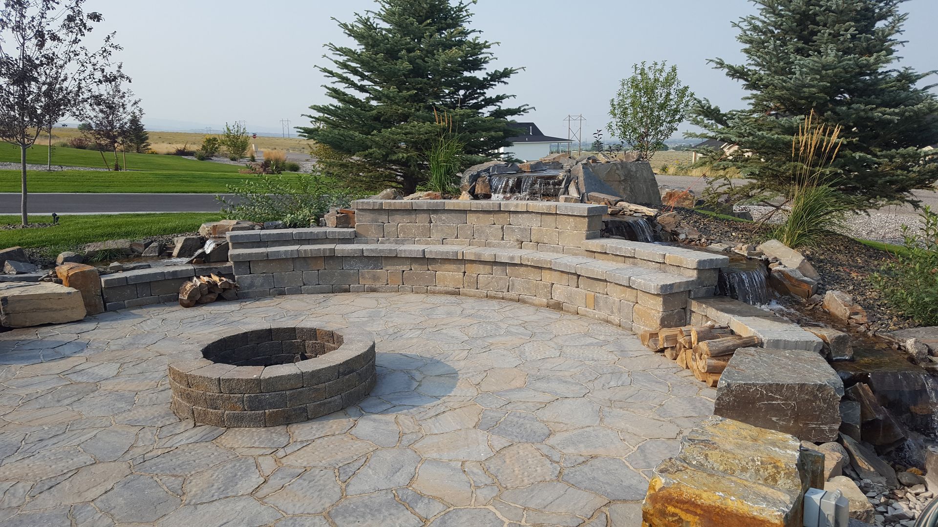 There is a fire pit in the middle of the patio.