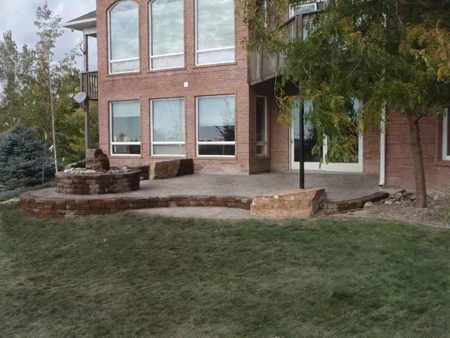 A large brick house with a patio in front of it