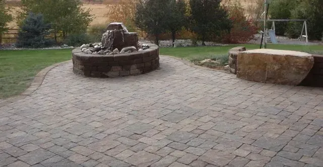 There is a fountain in the middle of the patio.