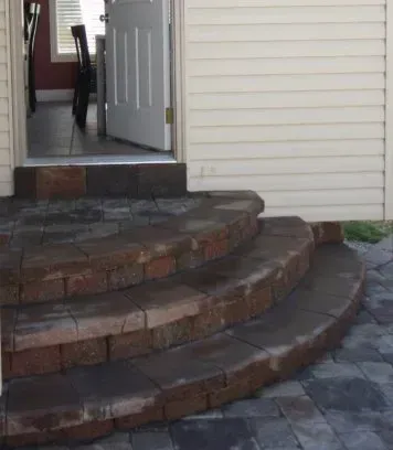 A set of brick steps leading up to a white house