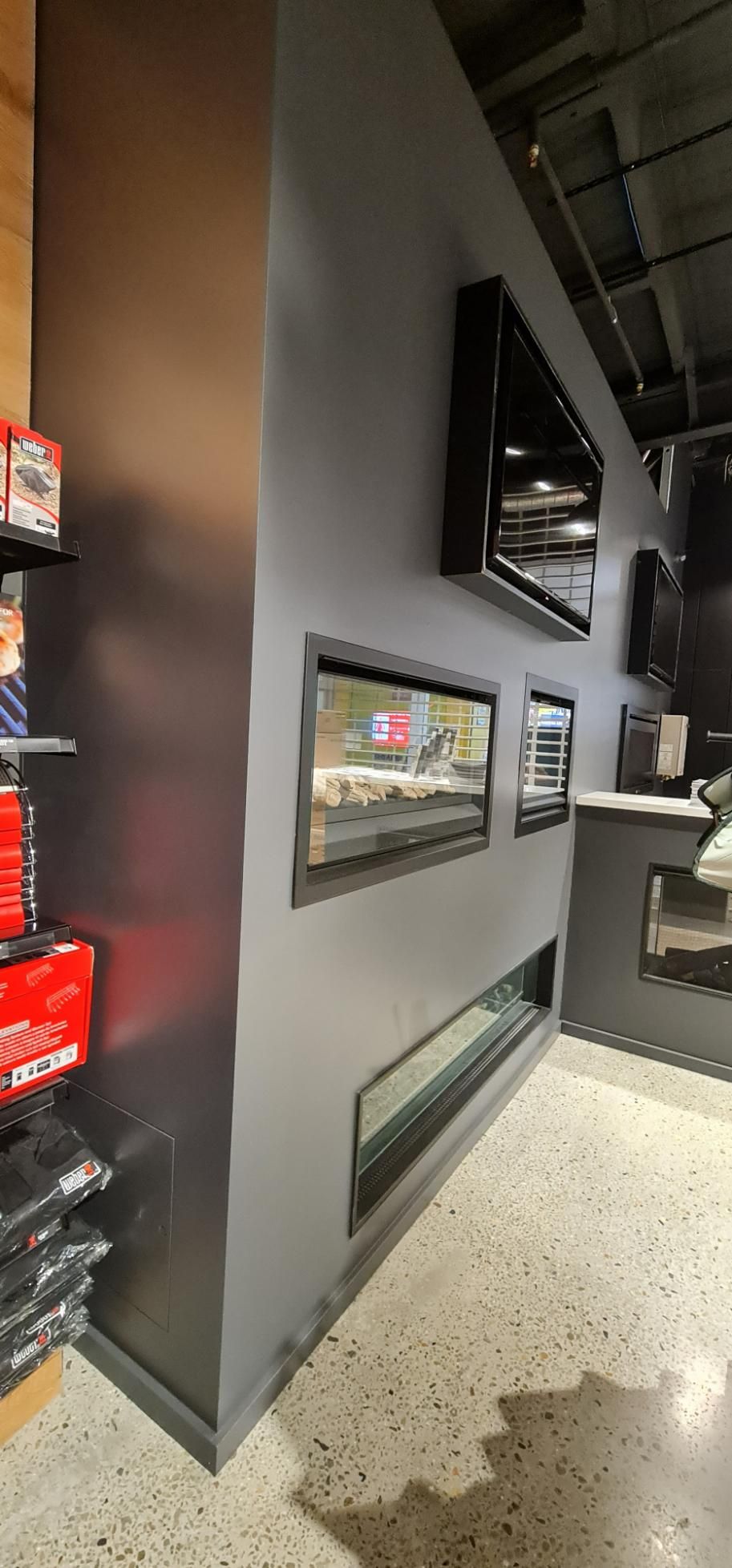 A Room With A Fireplace And Televisions On The Wall — Blue Painting & Decorating In Taylor, ACT