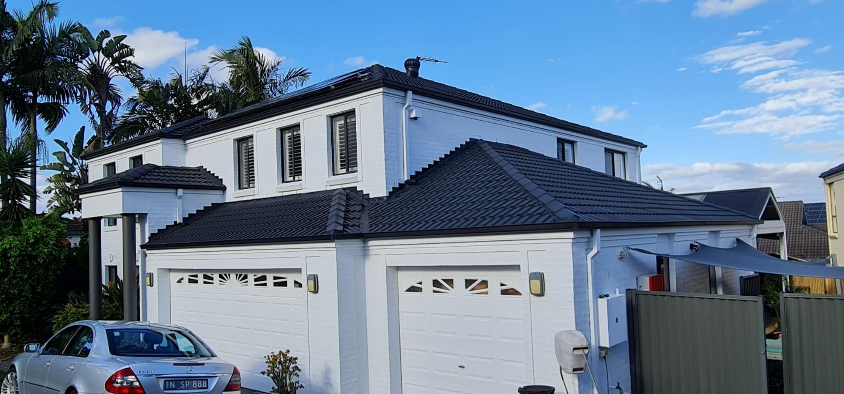 A White House With A Car Parked In Front Of It — Blue Painting & Decorating In Taylor, ACT