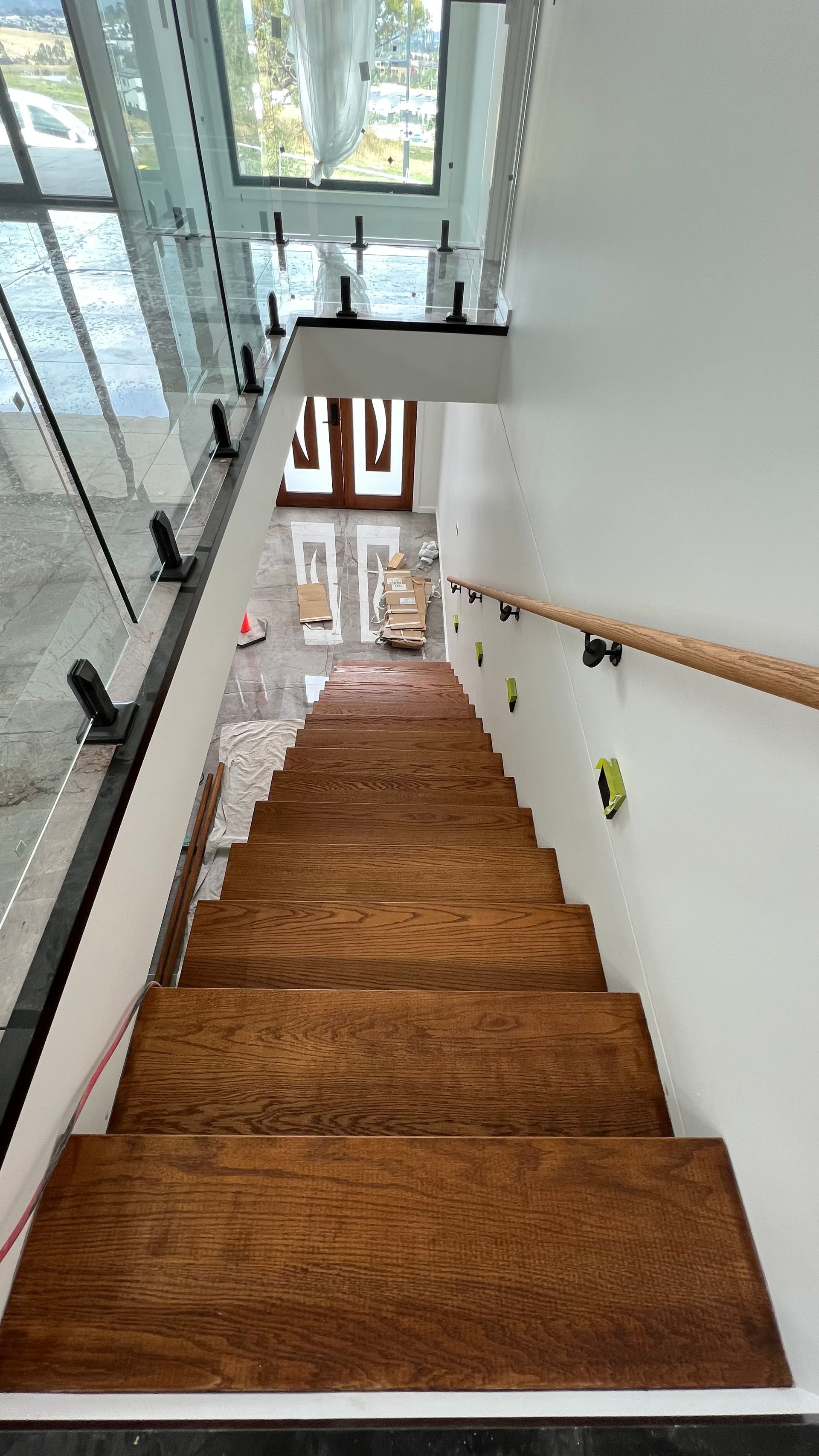 A Stairwell With Painting Equipment At The Bottom— Blue Painting & Decorating In Taylor, ACT