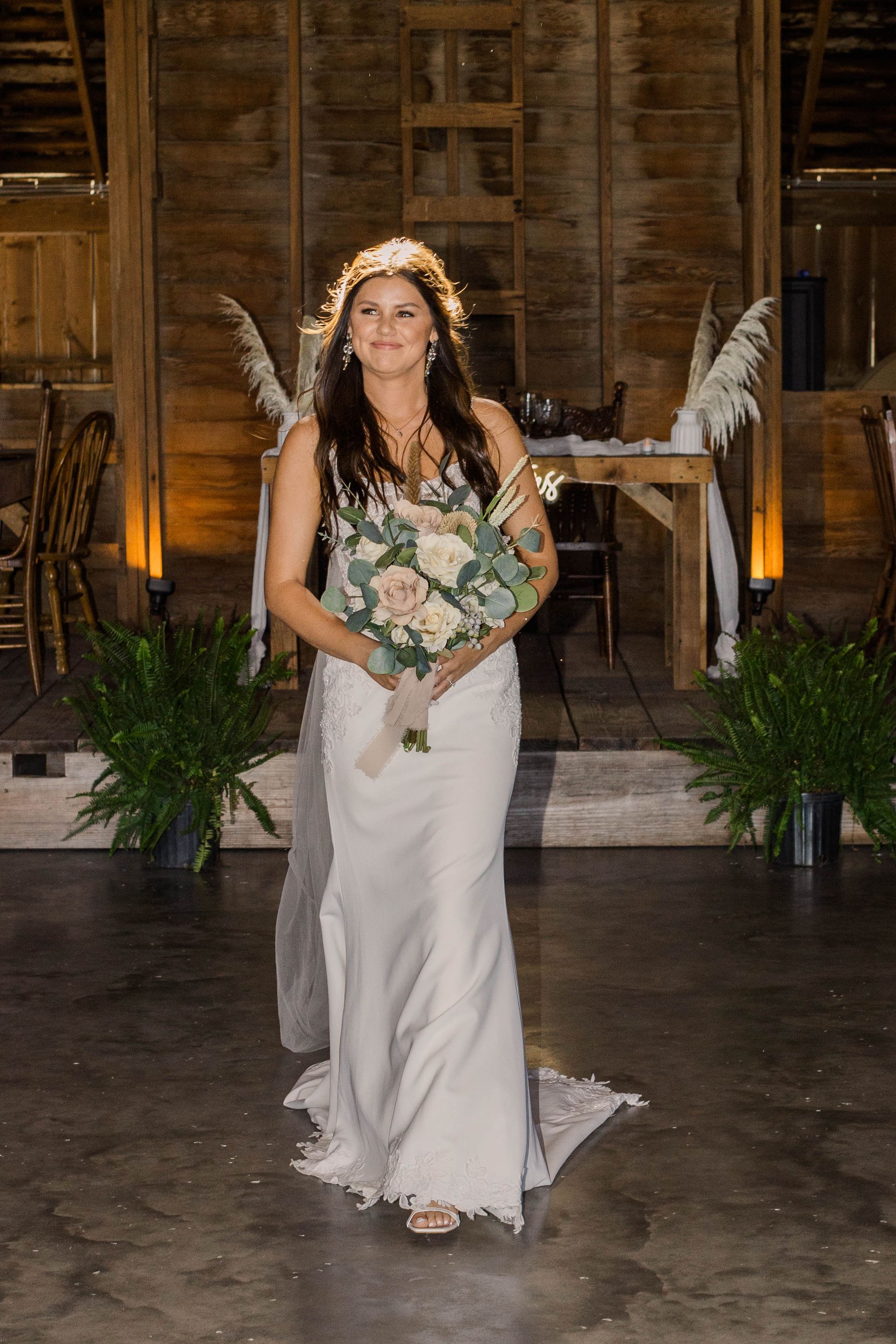 bride with boquet inside of the restored barn