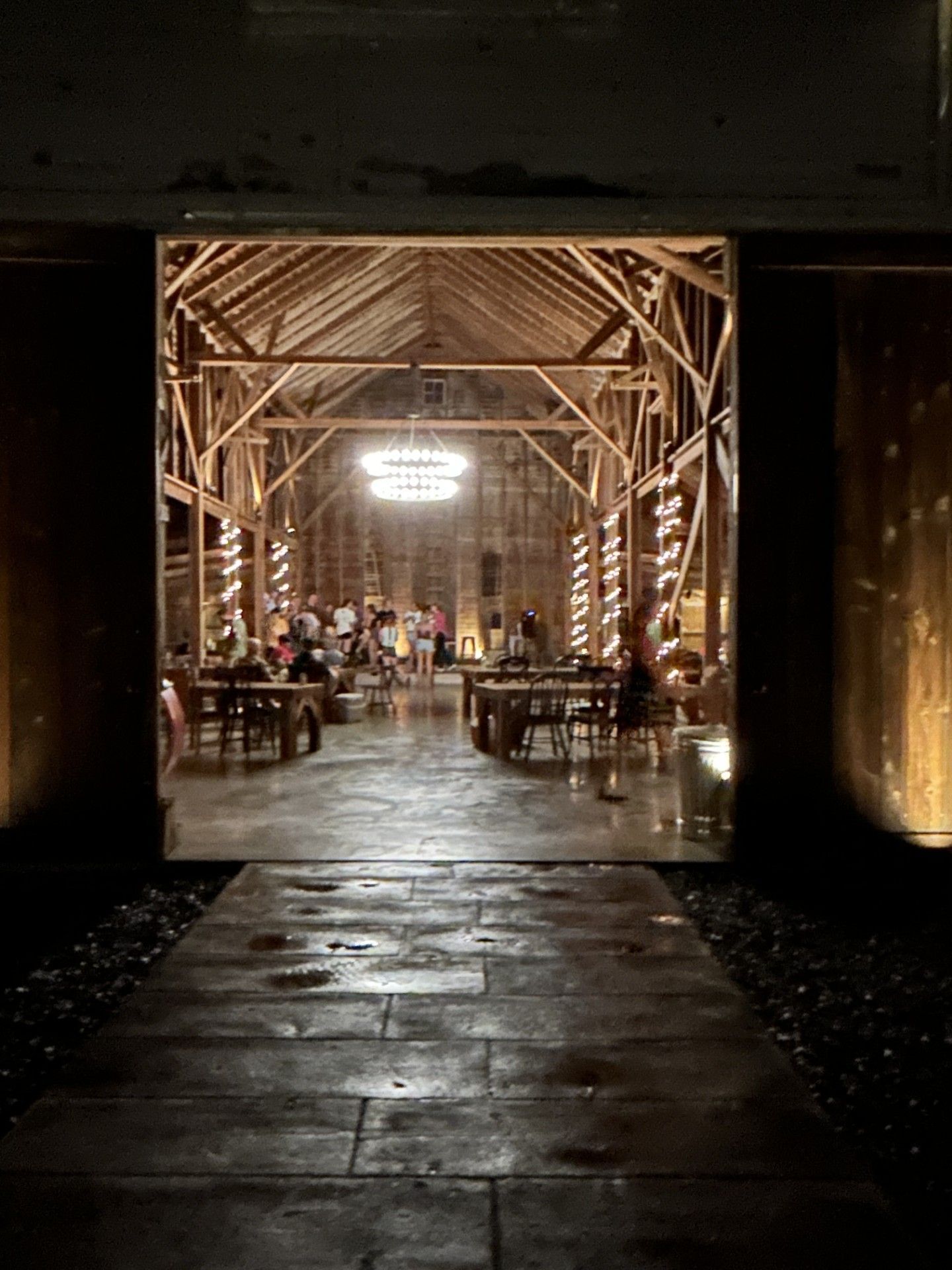 looking into barn with lights at night