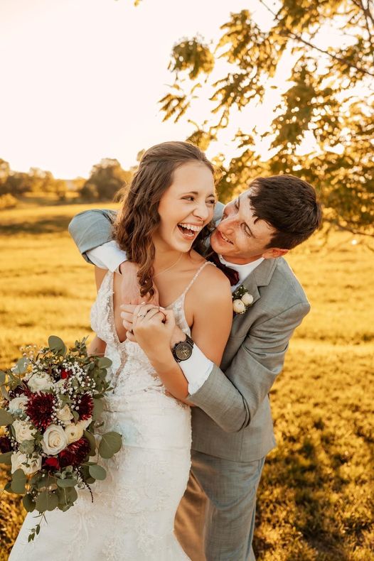 Beautiful bride and groom laughing at wedding day at the barn