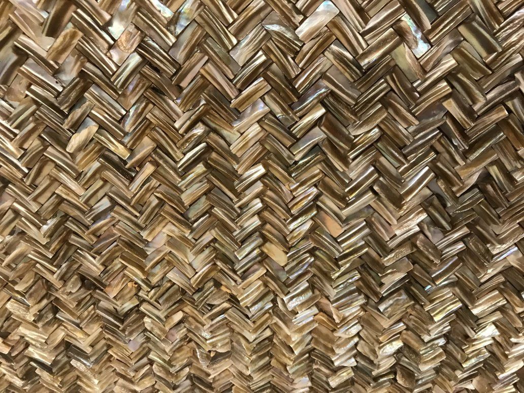 a close up of a tile with a herringbone pattern.