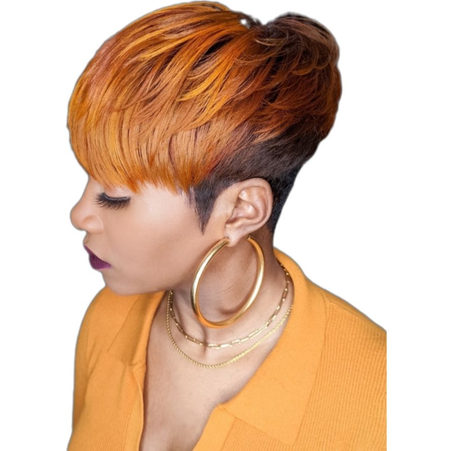 Woman with a short, layered, orange and brown haircut, wearing gold hoop earrings and a yellow shirt.