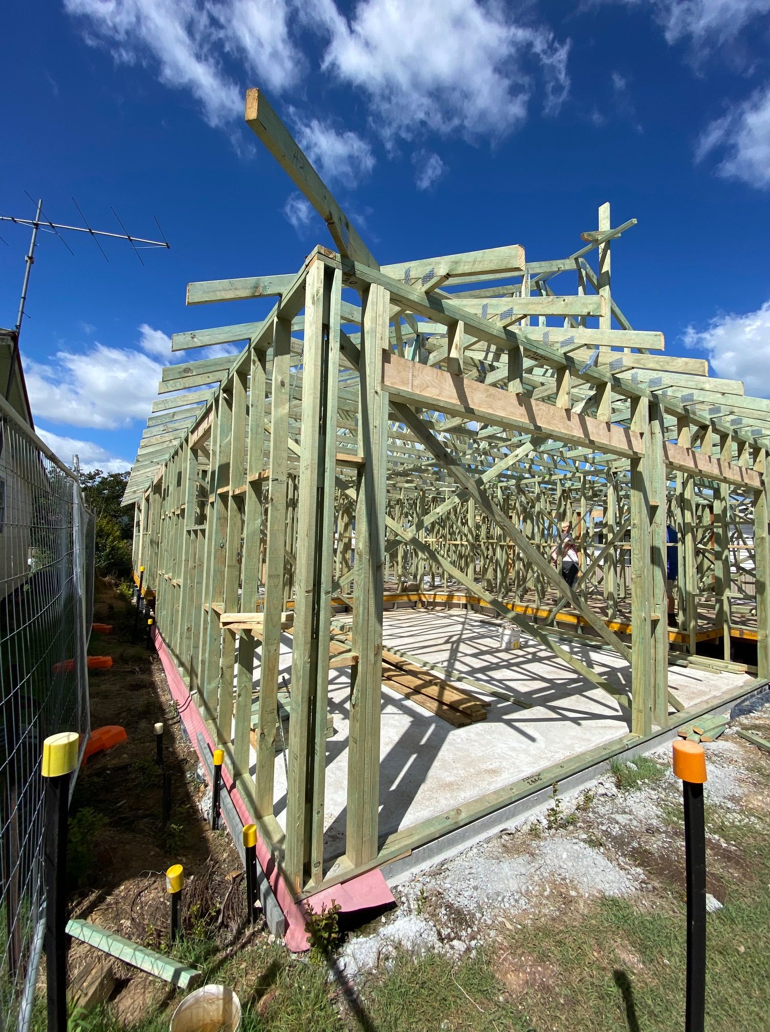 Wooden Frame of a Building Under Construction on a Concrete Foundation — BK Building Services Pty Ltd In Taree, NSW