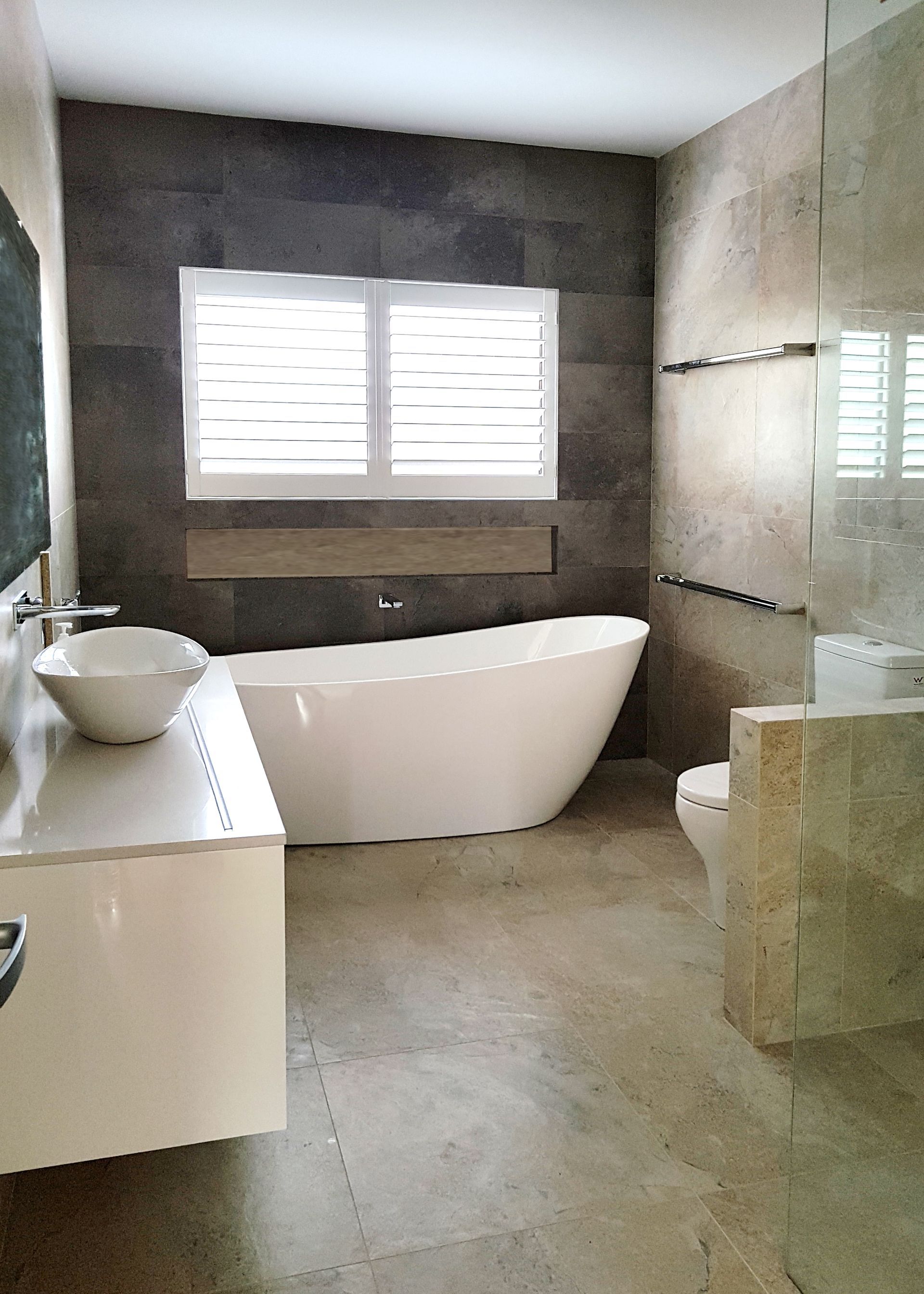 Modern Bathroom With White Tub, Sink, Toilet, and Tiled Walls and Floor — BK Building Services Pty Ltd In Taree, NSW