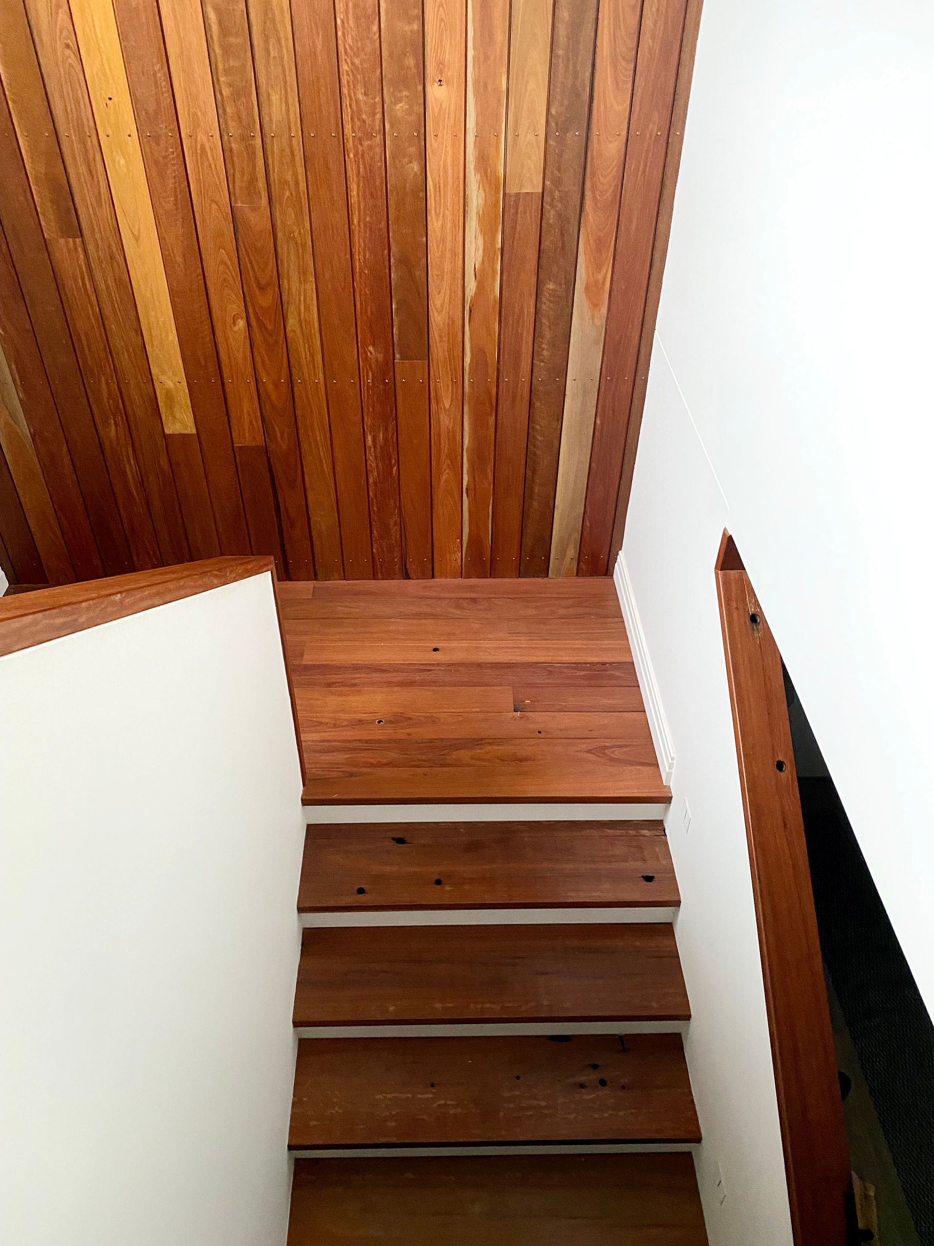 Wooden Stairs Leading Upward, With a Wooden Ceiling and White Walls — BK Building Services Pty Ltd In Taree, NSW