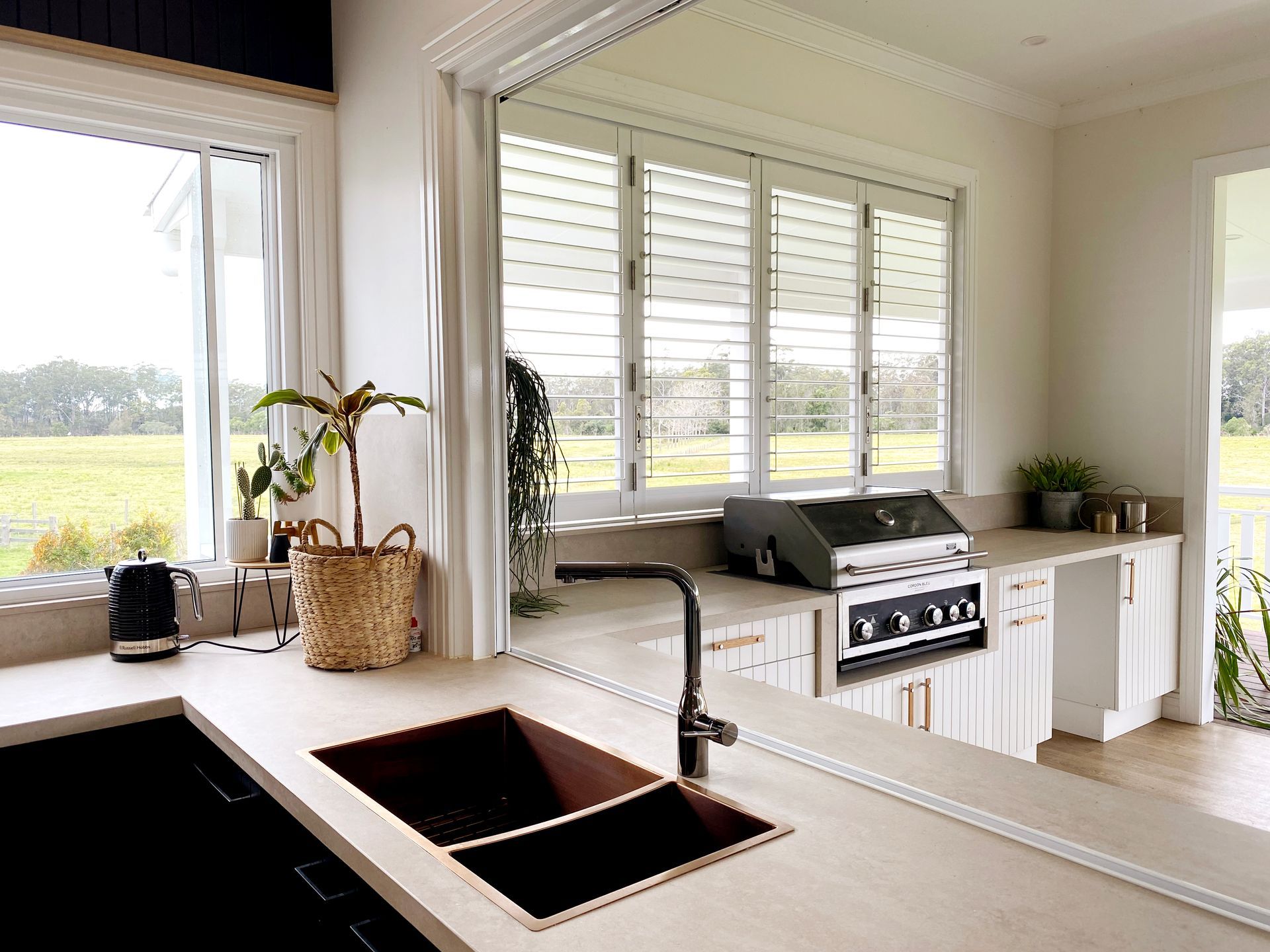 Kitchen With Sink, Counter, and Grill, Overlooking a Green Field — BK Building Services Pty Ltd In Taree, NSW