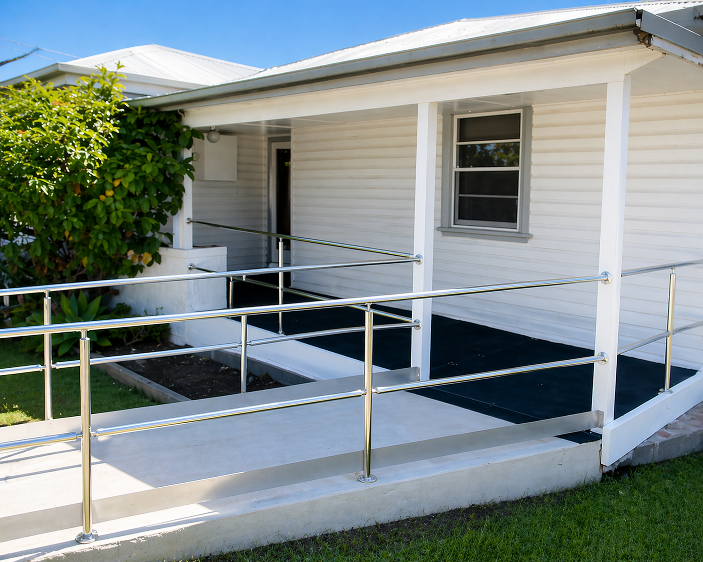 Accessible ramp leading to a white house porch with railings and a window — BK Building Services Pty Ltd In Forster, NSW