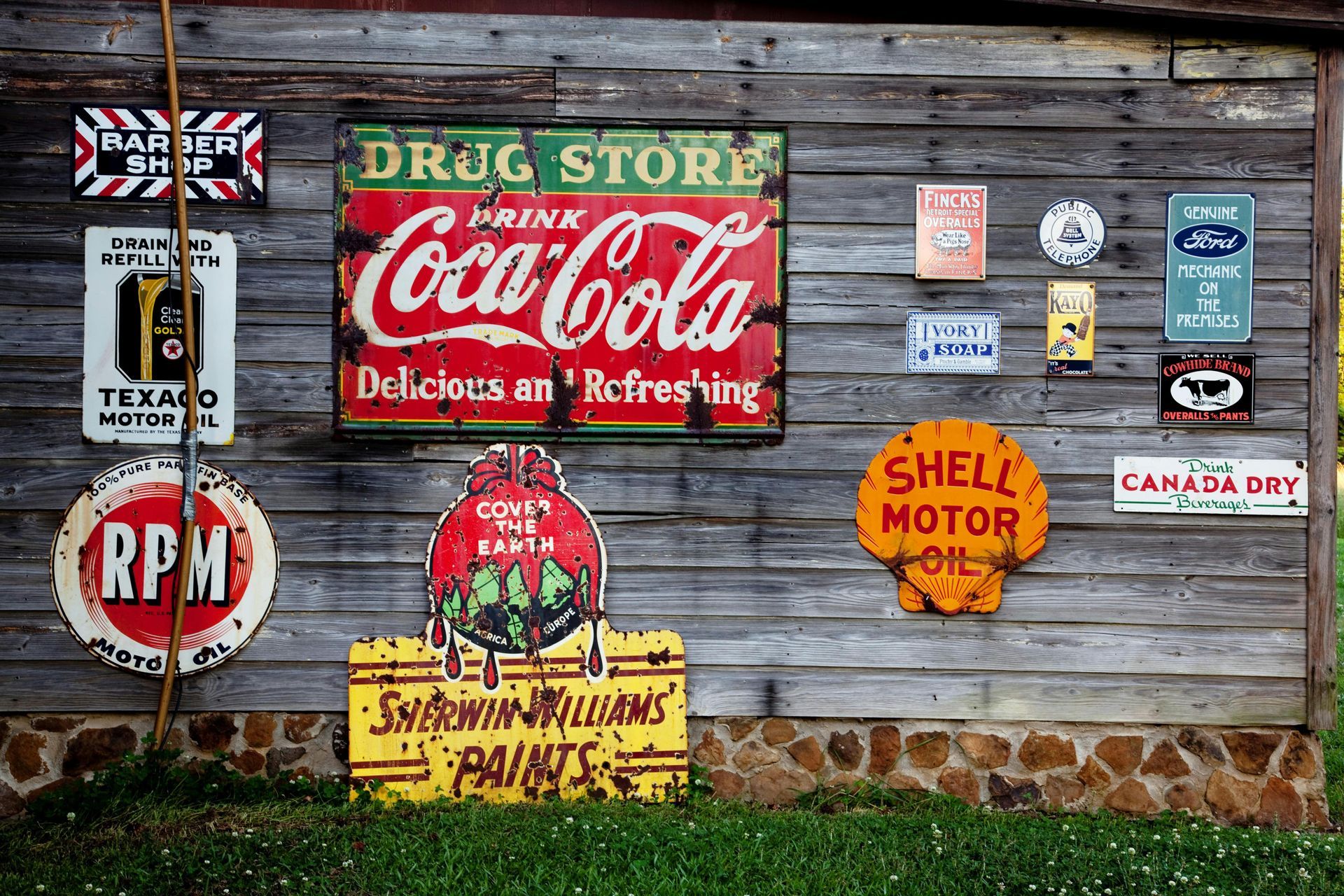 A wooden wall with a coca cola sign on it