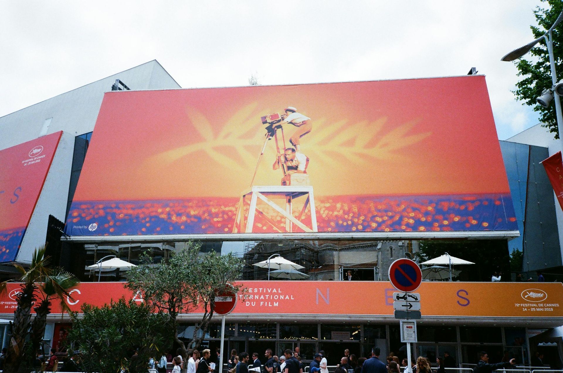 A large billboard on the side of a building advertising the cannes film festival