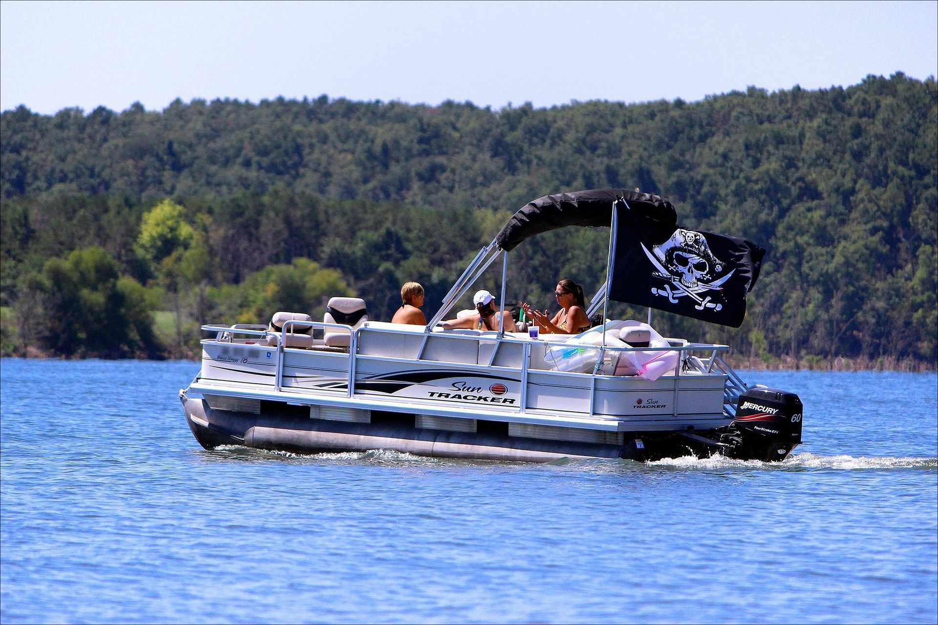 A pontoon floats across a lake. Smooth sailing with our general maintenance services!