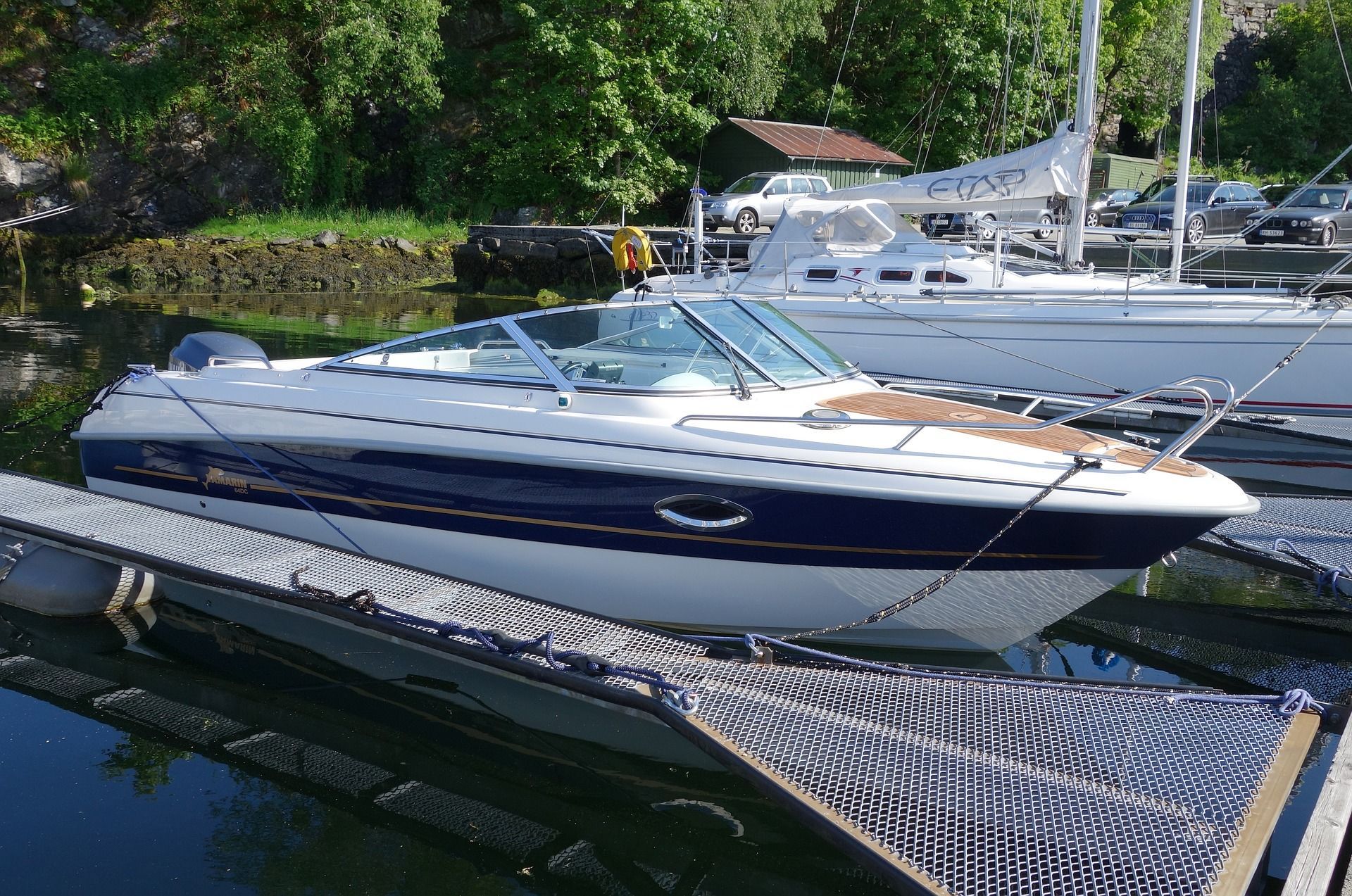 A boat sits docked on a lake