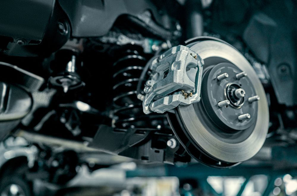 Car brake disc and caliper assembly, close-up view.