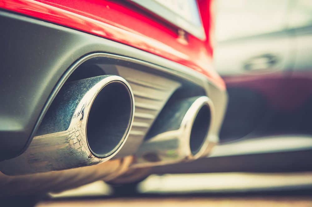 Close-up of a Red Car's Dual Exhaust Pipes, Showing Chrome Tips — Ottos Mufflers in Noosaville, QLD