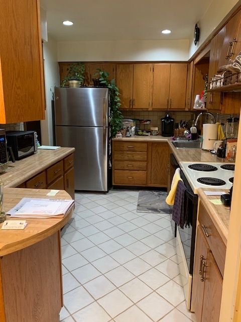 A kitchen with stainless steel appliances and wooden cabinets  | Cortlandt Manor, Westchester NY | Homescape Kitchens & Baths