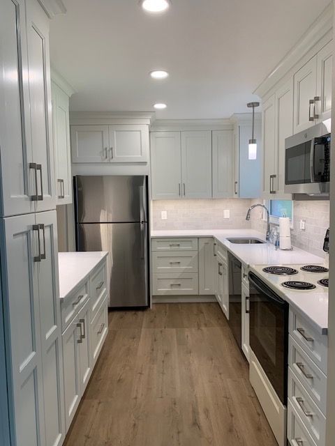 A kitchen with white cabinets and stainless steel appliances  | Cortlandt Manor, Westchester NY | Homescape Kitchens & Baths