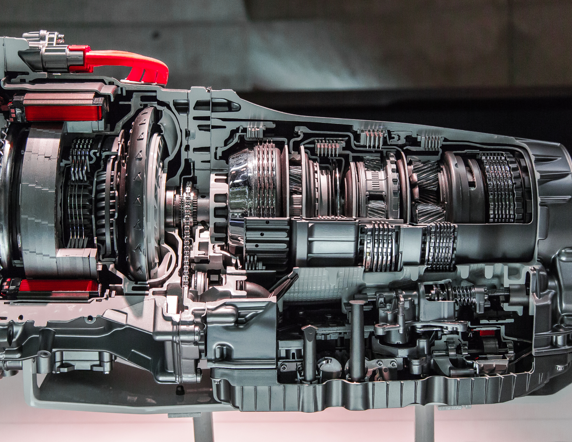 Cross-section of an automatic transmission, revealing internal gears, clutches, and fluid passages.