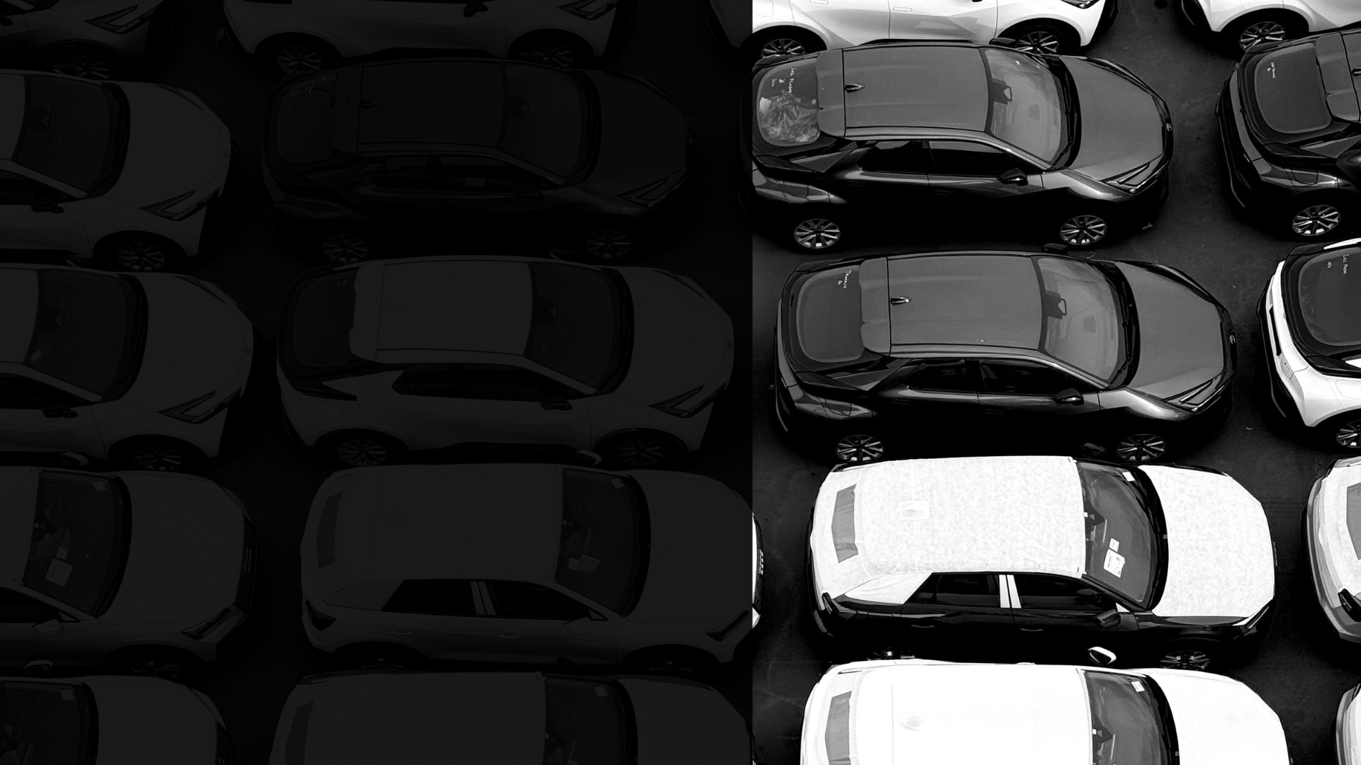 Rows of toy cars, left side shadowed, right side lit, in black and white.