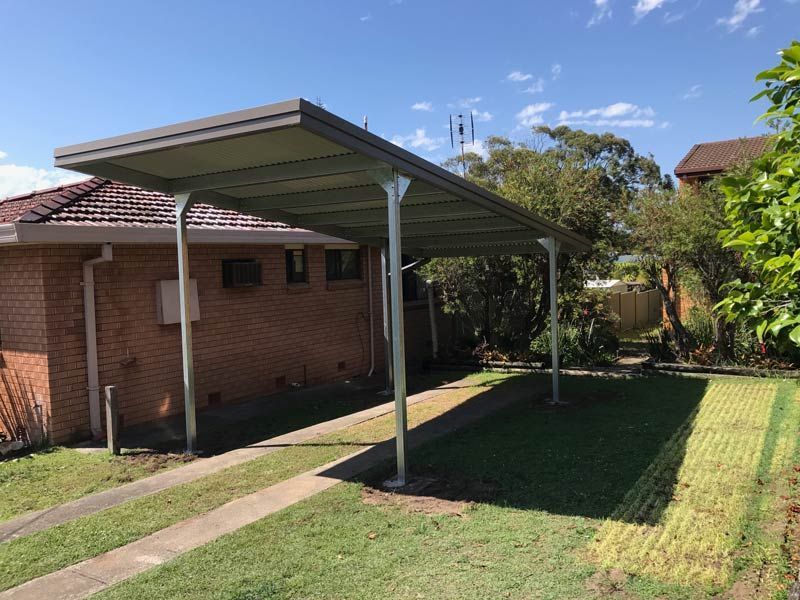 A Carport Is Sitting In Front Of A Brick House – South Kempsey NSW - Fair Dinkum Builds Macleay Valley Sheds
