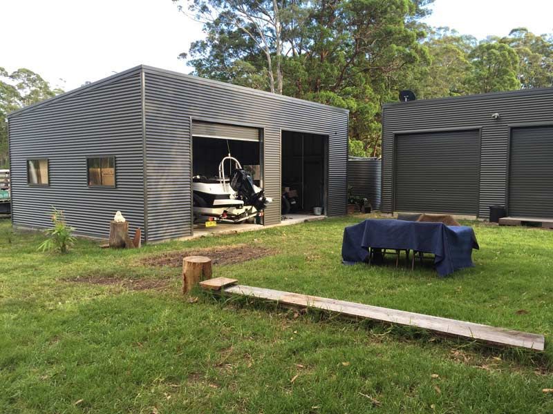 A Boat Is Parked In A Garage Next To A Picnic Table – South Kempsey NSW - Fair Dinkum Builds Macleay Valley Sheds